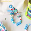 Llavero Colgante para Mochila de Pareja Linda de Dibujos Animados Creativos de Crayon Shin-Chan Genuino Colgante de Cadena para Teléfono Móvil Regalo Venta al por Mayor