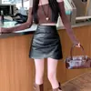 Falda plisada de cuero sintético ligeramente regordeta para mujer, otoño e invierno, nueva, de cintura alta, adelgazante, irregular, línea A, de longitud media, falda pantalón ajustada a la cadera