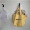Bolsa de balde nova estilo coreano para primavera e verão, de ombro único, grande capacidade, com estampa de letras, em lona, simples para estudantes, de viagem