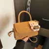 Bolsa Quadrada Pequena de Mola Estilo Hong Kong Ombro Único 2026 Nova Tendência Design de Nicho Moda Cor Sólida Bolsa Transversal de Alta Qualidade