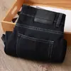 Estación europea verano fino negro azul súper suave antiarrugas cintura media-alta elástico para hombre casual de negocios jeans rectos