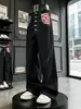 Jeans para hombre con estampado de bandera americana retro desgastada, pantalones largos de pierna ancha con múltiples botones, pantalones negros lavados de dobladillo curvo hasta el suelo