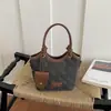 Bolso pequeño súper popular para mujer, nuevo modelo 2026, bolso cruzado tipo cubo color block de nicho de alta gama para el día a día