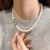 Lujo Ligero Estilo Francés Retro Diseño Personalizado Caja Trasera Hebilla Redonda Pulsera de Perlas Pulsera de Moda Elegante de Alta Gama para Mujer