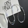Lujo ligero y sensación de alta gama, cadena cruzada para teléfono con cuentas de cristal iridiscente azul claro, llavero de diseño creativo, cadena larga para bolsos