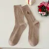Calcetines de mujer de caña media otoño e invierno patrón de cáñamo calcetines de Navidad bordado de muñeco de nieve moda todo a juego calcetines de felpa Zhuji