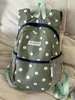 Mochila de lunares transfronteriza, mochila casual y ligera para viajes al aire libre, mochila ligera de gran capacidad para la escuela y el trabajo para estudiantes de secundaria y preparatoria.