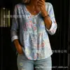 Nueva camisa estampada de cuello V abotonada de manga larga transfronteriza para mujer, elegante y con estilo para ir al trabajo, top casual único y moderno