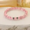 Europa y Estados Unidos pulsera de piedra de ojo de gato blanca transfronteriza para niñas alta gama moda Joker círculo único pulsera de cuentas redondas joyería al por mayor