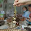 Cascabel Campana de Mano Carrillón Colgante de Bolsa Hecho a Mano Rayo de Sonido Cascabel Colgante Fruta Negra Indonesia Cáscara Fábrica Venta al por Mayor