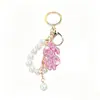 Llavero de arcilla de moda con signo de dólar incrustado de diamantes, cadena de perlas, colgante para bolso, colgante creativo de la fortuna, llavero