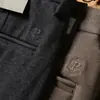 Pantalones de lana gruesa elástica para hombre de otoño e invierno 2023 pantalones de lana cepillada de alta gama rectos holgados de negocios casual