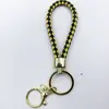 Venta al por mayor del fabricante Llavero de Cuerda de Aleación Tejida y Cuero Accesorios Colgantes Material PU Bolsas Pequeñas de Regalo Accesorios para Llaveros