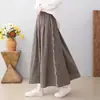 Colección Otoño 2026: Falda midi de cuadros de algodón y lino con cintura elástica, estilo artístico japonés, falda de línea A adelgazante para mujer