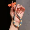Correa de anillo superestilosa con bloques de color, duradera y resistente con un gancho de metal, un cordón para teléfono anti-pérdida para mujer para ir de compras