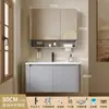 Tocador de baño engrosado y ahorrador de espacio con diseño en color crema, que cuenta con un lavabo redondeado, lavabo cerámico integrado y un lavabo de una sola pieza.