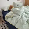 Lujo ligero, simple y suave, juego de cuatro piezas de ropa de cama para el hogar de estilo Muji catiónico con cordón para dormitorio estudiantil - un regreso a la simplicidad