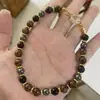 Nuevos accesorios de mano transfronterizos europeos y americanos, cadenas para teléfono de cristal natural, colgantes para teléfono de ojo de tigre amarillo y piedra de vesícula negra de comercio exterior
