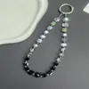 Nuevo cordón para teléfono móvil con cuentas de azúcar de cristal negro de alto valor, llavero para bolso estilo ins, cadena para teléfono móvil