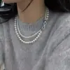 Cadena de cuello doblada de doble capa con hebilla dividida en forma de 8, elegante cadena de suéter de perlas de alta gama, accesorios de cadena de clavícula de nicho de lujo ligero