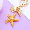 Llavero de Estrella de Mar de Diamante Europeo y Americano para Coche Colgante de Bolso de Metal para Mujer Anillo de Llavero Oceánico Regalo de Negocio Transfronterizo