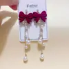 Pendientes de lazo de perlas vintage estilo francés para mujer, accesorios para la oreja aterciopelados versátiles y elegantes, tachuelas de moda de lujo ligero