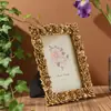 Marco de fotos de resina dorada estilo europeo de alta venta transfronteriza, manualidades decorativas para el hogar redondas y cuadradas, adornos de escritorio