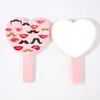 Espejo de mano en forma de corazón disponible en stock del fabricante, espejo de maquillaje portátil en forma de corazón, regalo promocional corporativo creativo, espejo de belleza al por mayor