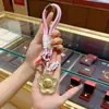 Chaveiro Dourado Ouro Puro 999 Corrente para Celular Bolsa Pingente com Dinheiro para Gastar Ano Novo Presentes Pequenos Culturais e Criativos Atacado
