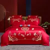 Nuevo conjunto de boda de cuatro piezas 100% algodón bordado 2026, con un diseño lujoso y elegante de algodón de fibra larga, en estilo chino tradicional y color rojo vibrante para bodas
