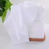 Toalla cuadrada blanca de punto de urdimbre al por mayor toalla pequeña especial para hotel desechable fuerte absorción de agua sin pelusa toallitas húmedas cuadradas
