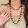 Colar de Metal Retro Laço Antigo Estilo Étnico Boêmio Simples Versátil Longo Pingente de Argola 2025