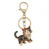 Llaveros lindos de mascotas transfronterizos, varios estilos de gatitos que caminan, aleación de zinc con diamantes de imitación y aceite, llaveros creativos para accesorios de mochila