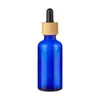 Botellas de aceite esencial azules al por mayor, disponibles en varios tamaños, con tapas gotero resistentes a la luz, botellas vacías para sueros y botellas dispensadoras cosméticas portátiles