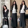 Conjunto de maternidad de dos piezas con capucha minimalista para Otoño/Invierno 2026, con una elegante falda midi de corte amplio