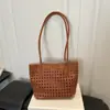 Bolsa de ombro tote versátil com padrão trançado vazado de nicho europeu e americano, nova moda outono 2026