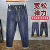 Novas calças casuais de outono e inverno, cintura elástica moderna, forradas com fleece, jeans espessado, calças masculinas soltas stretch slim-fit