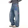 Jeans divertidos bordados estilo americano para hombres y mujeres, pantalones largos de otoño de moda callejera ligeramente acampanados con un diseño elegante y perneras anchas