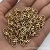 Estoque do Fabricante Liga de Zinco Preto Fosco Figura Oito Dourado Claro KC Anel de Ligação Metálica Figura Oito Rotativa