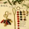 Kit de material DIY para fazer um móbile de casca de fruta, um sino pendurado de cura, com frutas pretas indonésias, estramônio, lírio d'água e rotim