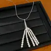 Collar de perlas con borla de circonita, cadena para suéter casual y versátil, juego de joyería de nicho de lujo ligero de alta gama al por mayor