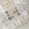 Accesorios para Uñas Artísticas Caja de 12 Compartimentos Mariposa Metálica Mixta Cuervo Corazón Cruz Cinta Lazo Decoración para Uñas de Forma Especial