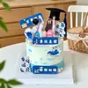 Decoración de Pastel Temporada de Graduación 2026 Mochila para Niños y Niñas Topper Acrílico "Surcando Vientos y Olas, Futuro Prometedor" Topper para Pastel