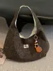 Bolsa de tela de gran capacidad para mujer otoño e invierno 2026 nueva bolsa de lona versátil bandolera estilo perezoso bolsa de mano para ir al trabajo