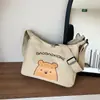 Bolsa Transversal de Lona Casual para Mulheres 2025 Nova Marca Tendência para Estudantes Universitários Bolsa de Letras de Nicho Bolsa de Ombro Versátil Formato Dumpling para Mulheres