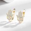 Pendientes de explosión transfronterizos europeos y americanos chapados en cobre con microincrustaciones de oro real y circonitas en forma de ojo de diablo, exquisitos pendientes de fiesta de moda.