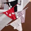 Nova Tanga Sexy de Cor Sólida Macia de Seda de Gelo para Mulheres de Cintura Baixa Sem Costura Divertida com Pom-Pom Fofa Calcinha T para Mulheres