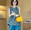 Conjunto de dos piezas de verano para mujer, moderno y elegante, nuevo conjunto casual de top sin mangas de lunares y pantalones de pierna ancha, adelgazante y rejuvenecedor para mujer