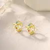 Pendientes de lazo dorados de moda transfronterizos con un toque de nicho de alta gama, accesorios para la oreja con incrustaciones de gemas de colores y diamantes al por mayor