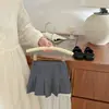 Falda corta plisada de estilo universitario para niñas en verano, elegante, de color liso, cintura elástica, versátil, anti-exposición, media falda, ropa para niños